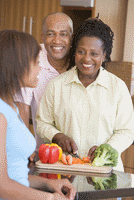 teen and parents cooking