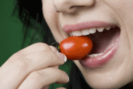 woman eating tomato
