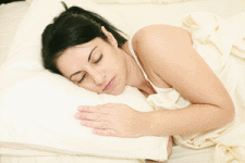 woman snuggled up in bed sleeping