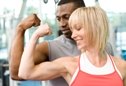 man and woman flexing muscles
