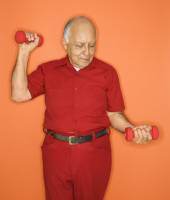 senior man using dumbbells