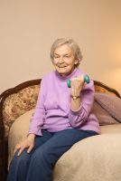 senior woman lifting dumbbell weights