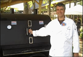 guy standing by outdoor meat smoker